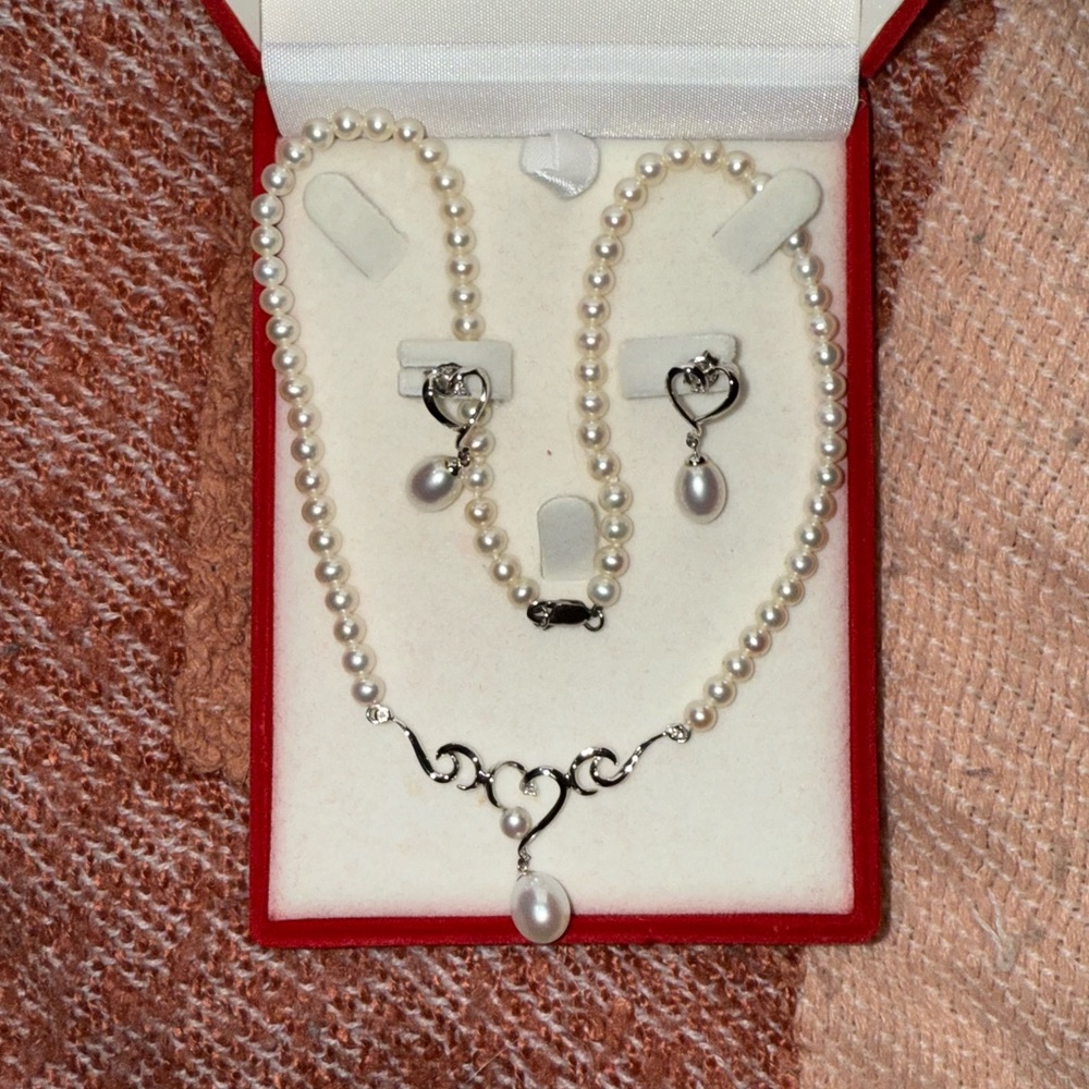 Real pearl set with heart necklace and earrings. Never worn but have kept